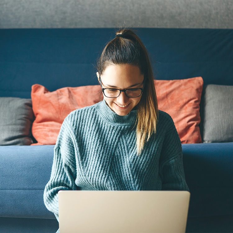 Girl working on laptop from home or student studying from home or freelancer. Or she is watching a video or using the Internet.